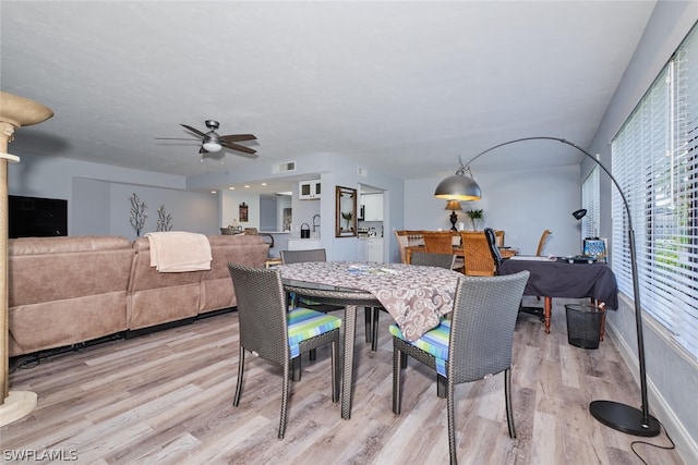 dining room featuring light hardwood / wood-style floors and ceiling fan