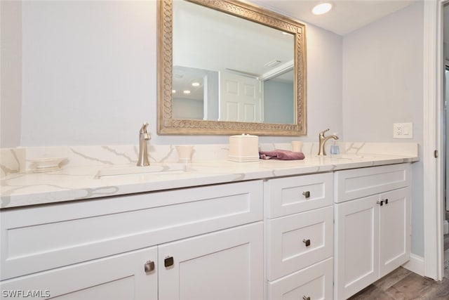 16580 Waters Edge Ct Unit 102, Fort Myers, FL 33908 - full bathroom with double vanity, wood finished floors, and a sink