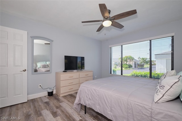 bedroom with ceiling fan and light wood-type flooring