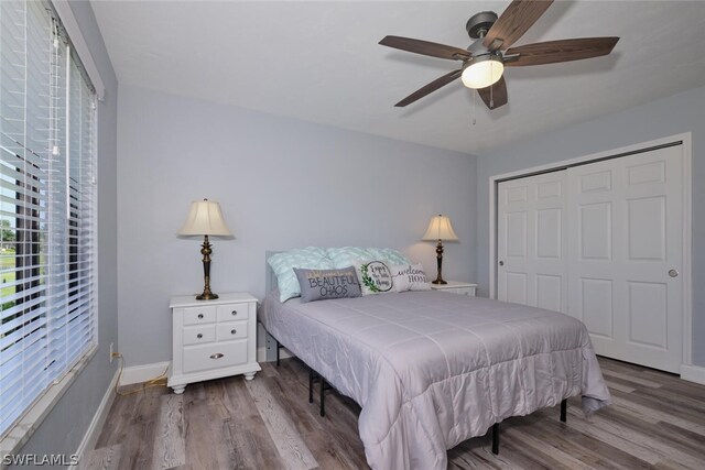 bedroom with a closet, ceiling fan, and hardwood / wood-style floors