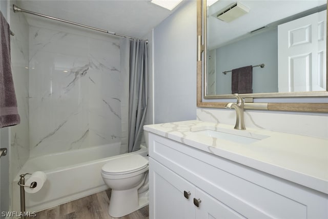 full bathroom featuring toilet, hardwood / wood-style floors, vanity, and shower / tub combo with curtain