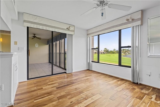 spare room featuring ceiling fan and light hardwood / wood-style flooring