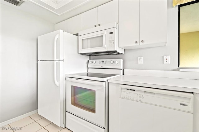 kitchen featuring light tile patterned floors, white appliances, and white cabinets