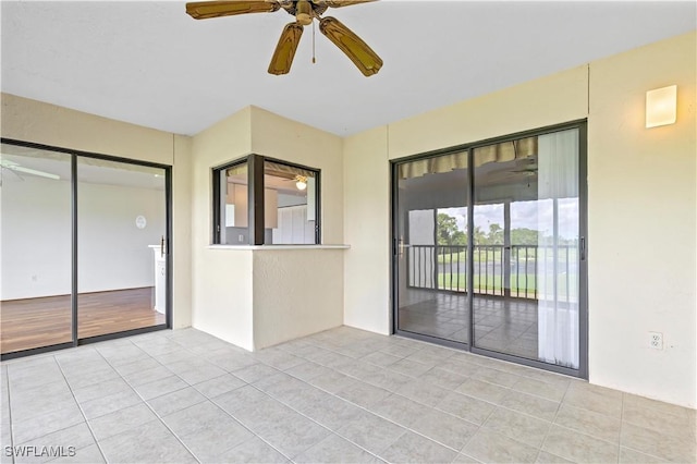 interior space with ceiling fan