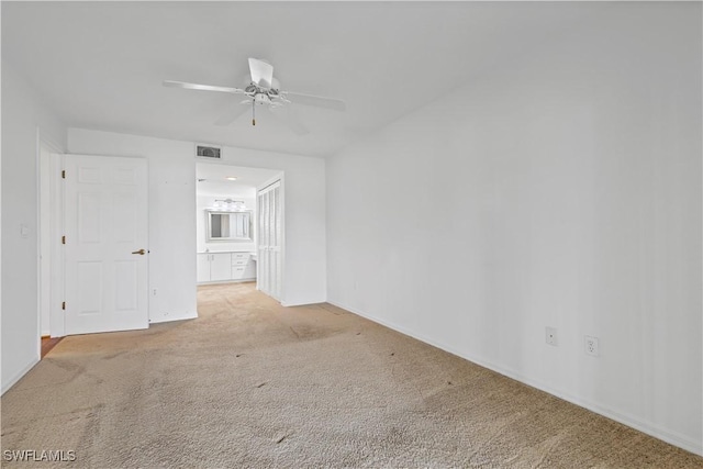 carpeted empty room featuring ceiling fan