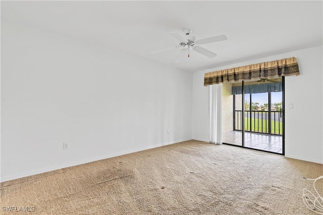 unfurnished room featuring ceiling fan and carpet flooring