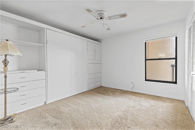 unfurnished bedroom featuring carpet and ceiling fan