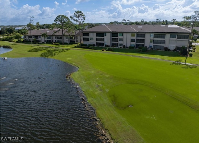 view of property's community with a water view and a lawn