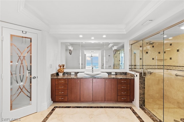 bathroom featuring a shower with door, tile patterned floors, vanity, a tray ceiling, and ornamental molding