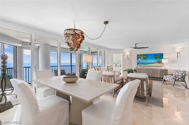 dining area featuring radiator heating unit, ceiling fan with notable chandelier, light tile patterned floors, and plenty of natural light