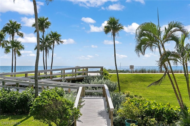 dock area with a water view and a yard