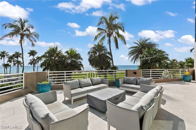 view of patio with an outdoor living space and a water view