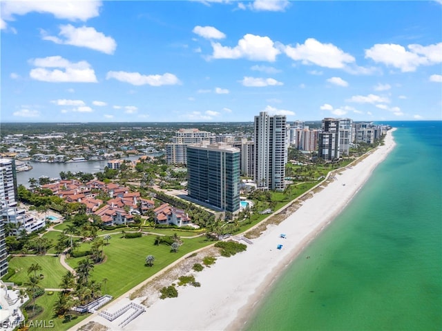 birds eye view of property featuring a water view and a beach view