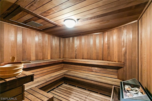 view of sauna / steam room featuring wooden ceiling, wooden walls, and wood-type flooring