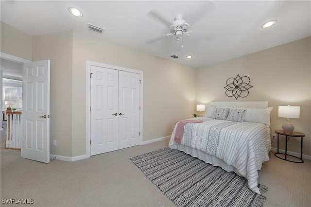 bedroom featuring light carpet, a closet, and ceiling fan