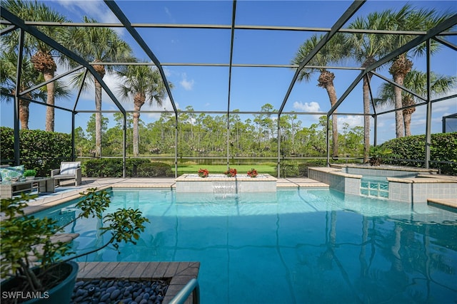 view of swimming pool with pool water feature, a hot tub, and glass enclosure