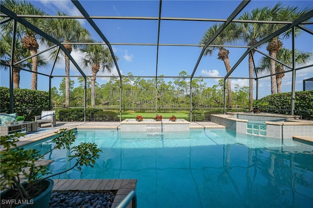 view of swimming pool featuring a lanai, a patio area, pool water feature, and a jacuzzi