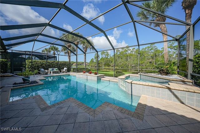 view of pool with a patio, an in ground hot tub, and glass enclosure