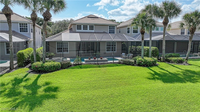 back of house with a lanai, a patio area, and a lawn