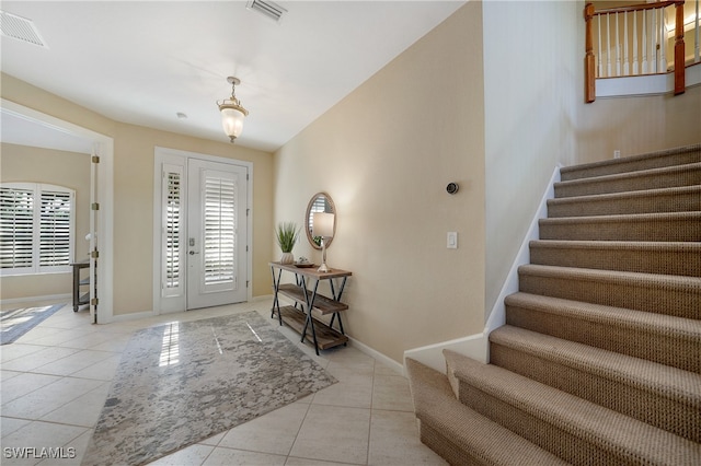 tiled foyer entrance with french doors