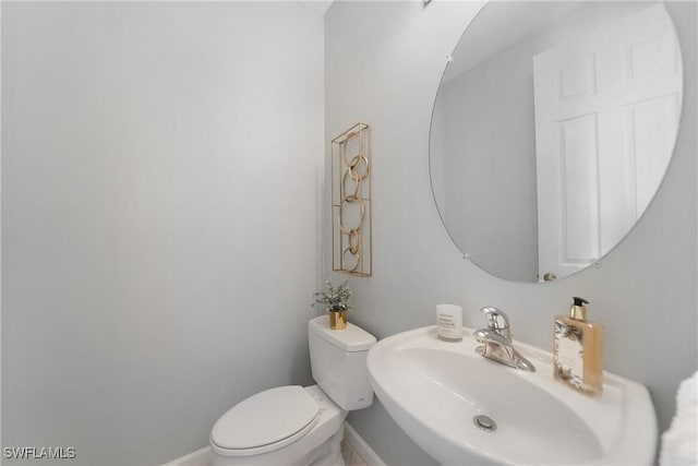 bathroom with toilet and sink