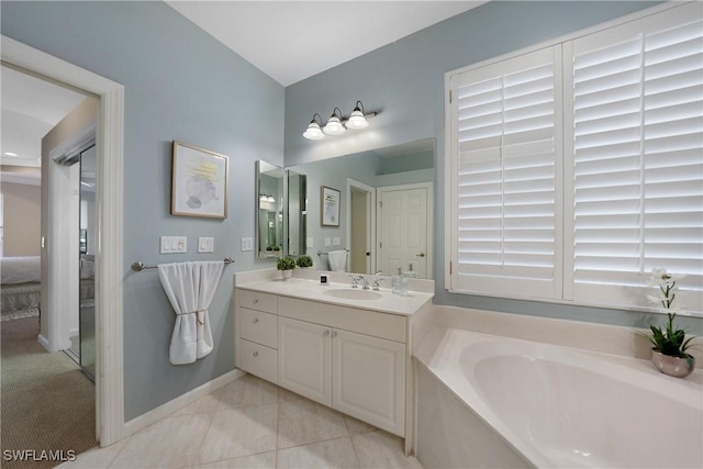 bathroom featuring vanity, a bath, and tile patterned flooring