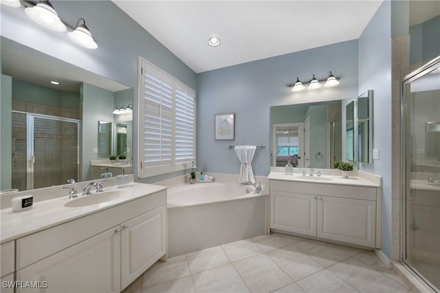 bathroom with tile patterned flooring, vanity, and separate shower and tub