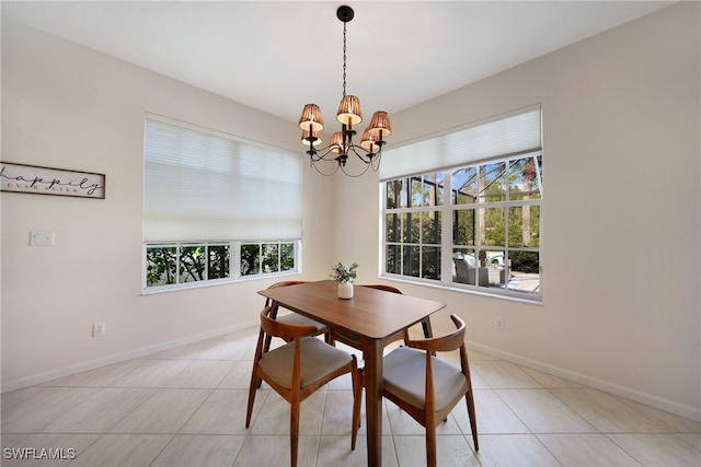 tiled dining room with a chandelier