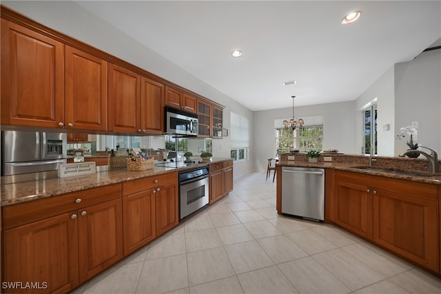 kitchen featuring light tile patterned flooring, sink, a chandelier, and stainless steel appliances