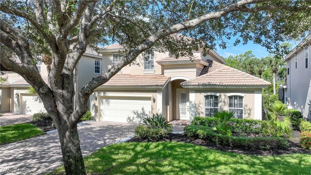 view of front of house featuring a garage and a front lawn