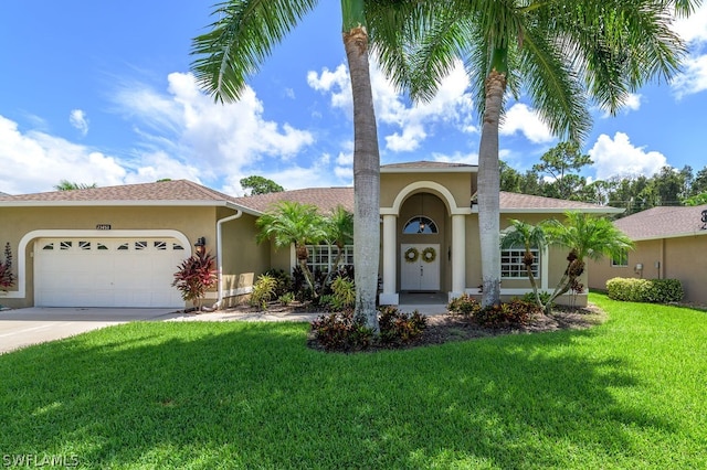 view of front of property featuring a garage and a front lawn