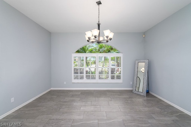 unfurnished room with tile patterned floors and an inviting chandelier