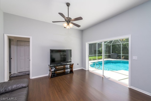 living room with vaulted ceiling, ceiling fan, and dark hardwood / wood-style floors