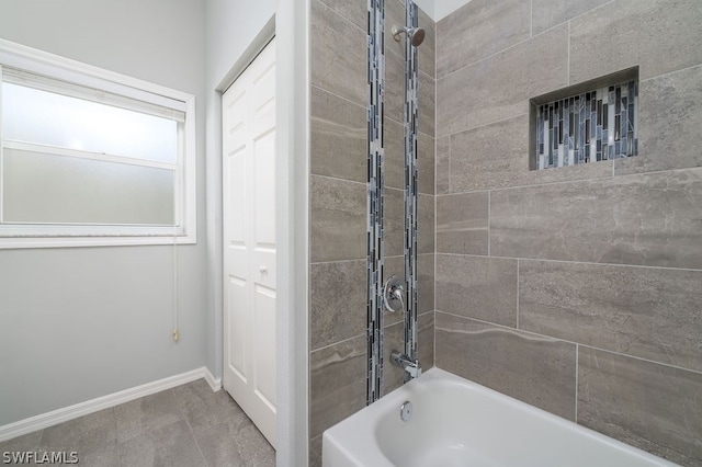 bathroom featuring tiled shower / bath and tile patterned floors