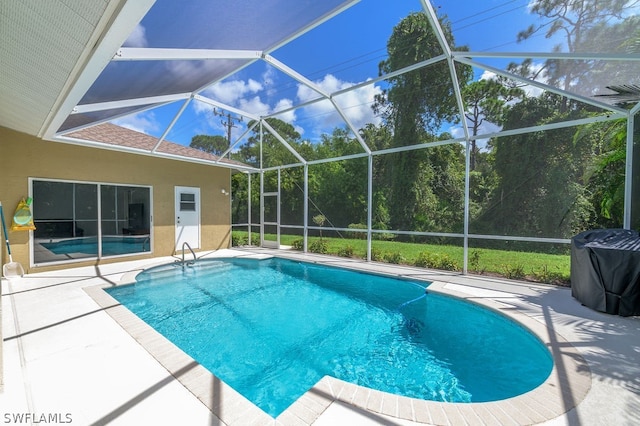 view of pool with a patio and a lanai