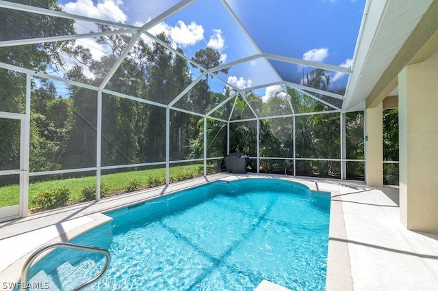 view of swimming pool with glass enclosure