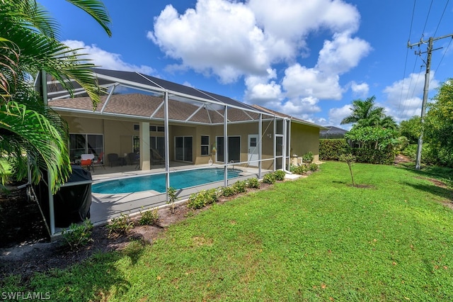 view of pool featuring a lawn and a lanai