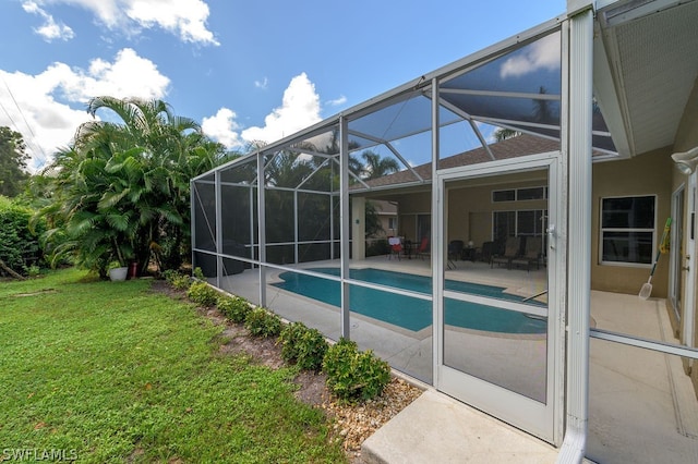 view of swimming pool with a patio area, a lawn, and glass enclosure