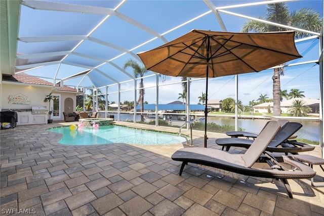 view of swimming pool with a lanai, exterior kitchen, a patio area, and a water view