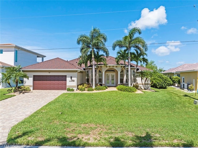 view of front facade with a front yard and a garage