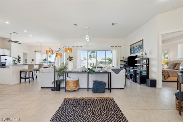 tiled living room with ceiling fan