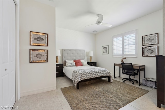 tiled bedroom with ceiling fan and a closet