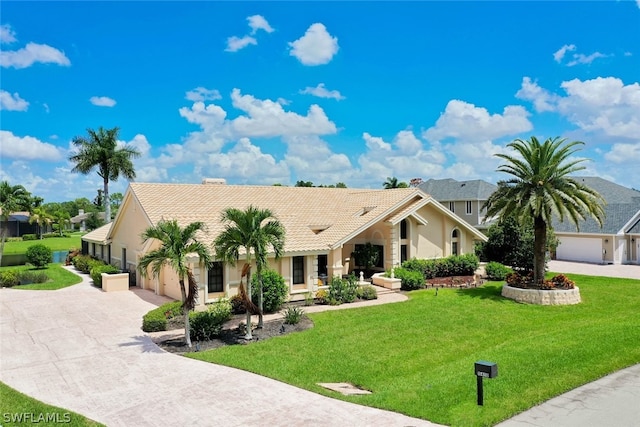 view of front of house featuring a garage and a front yard