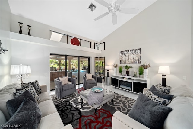 tiled living room with high vaulted ceiling and ceiling fan