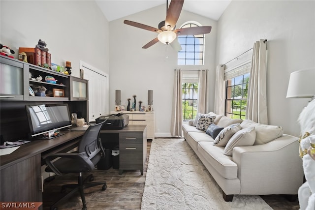 home office with dark hardwood / wood-style flooring, ceiling fan, and high vaulted ceiling