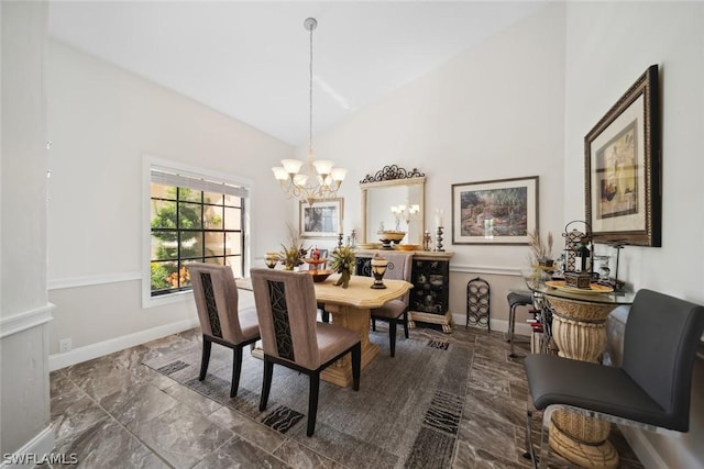 dining space featuring a notable chandelier and high vaulted ceiling