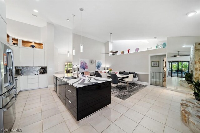 kitchen with ceiling fan, tasteful backsplash, pendant lighting, white cabinets, and sink