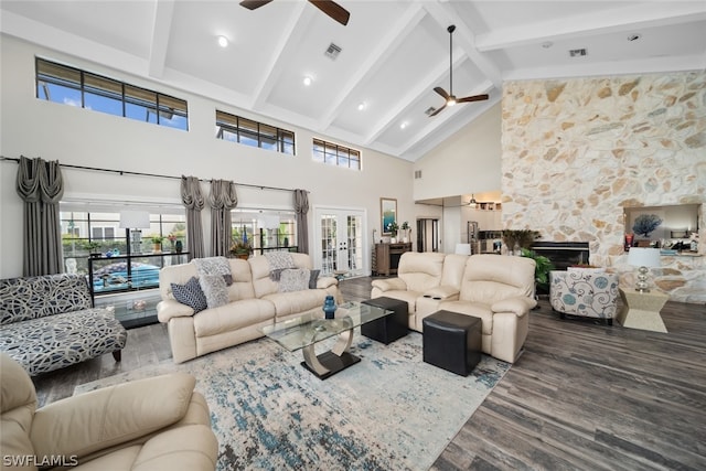 living room featuring a fireplace, hardwood / wood-style floors, high vaulted ceiling, and ceiling fan