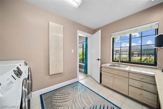 bedroom featuring sink, light tile patterned flooring, and independent washer and dryer