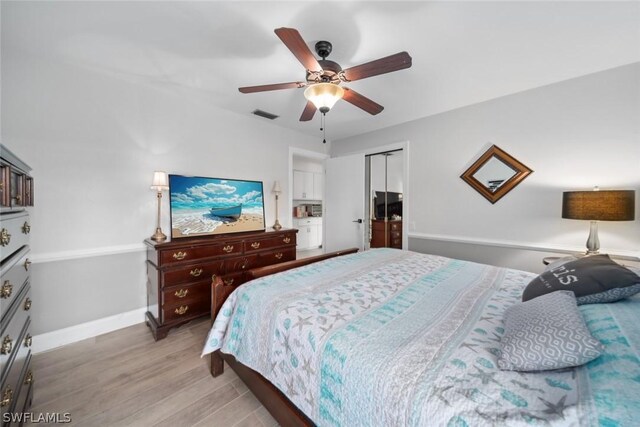 bedroom featuring hardwood / wood-style flooring, a closet, and ceiling fan